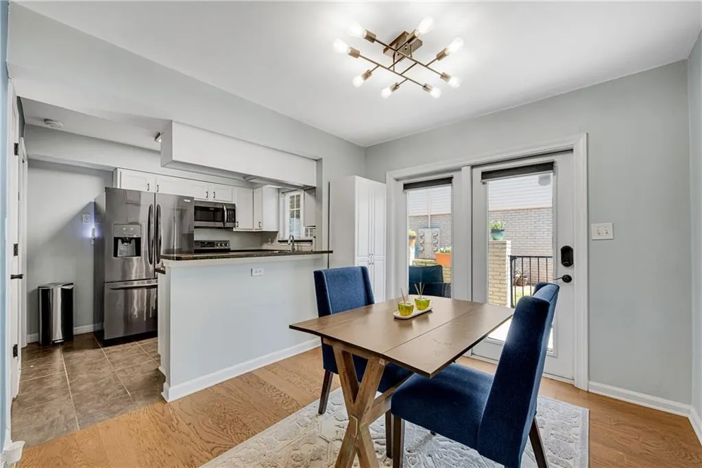 Dining area with a chandelier and light tile floors