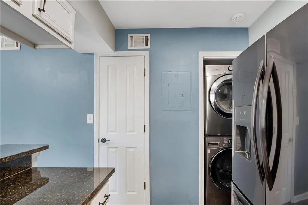 Laundry room featuring stacked washer and clothes dryer