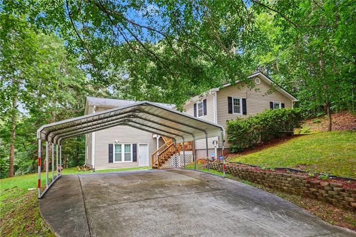 Expansive covered carport provides sheltered parking