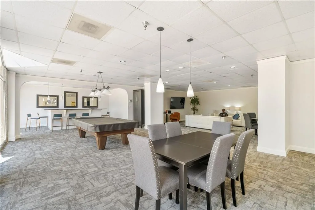 Dining room with a paneled ceiling, carpet, and pool table
