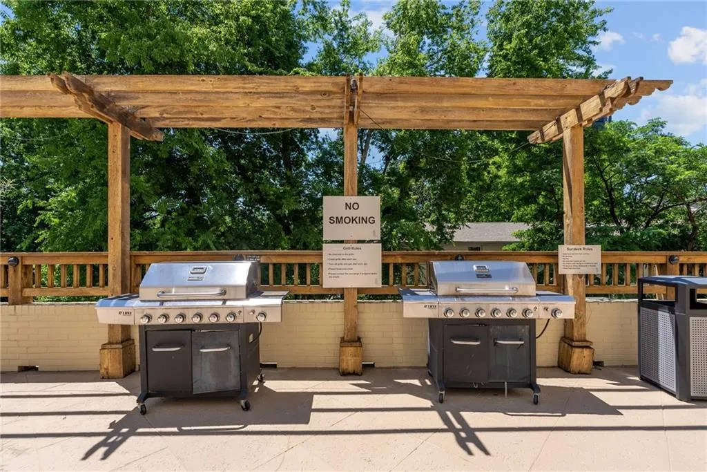 View of patio with a pergola and area for grilling