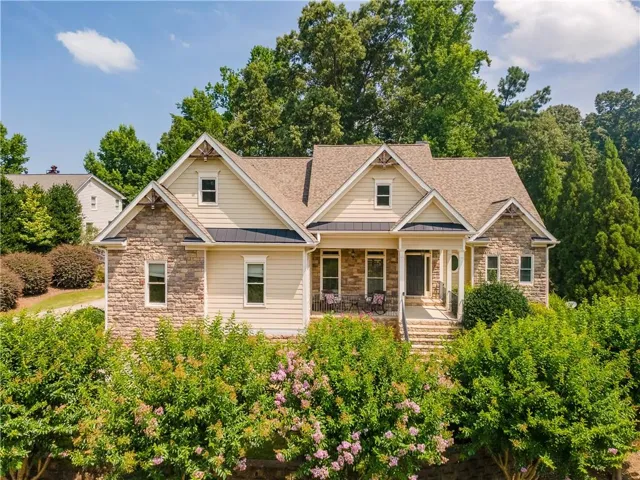 Craftsman-style home featuring a prominent stone and siding exterior