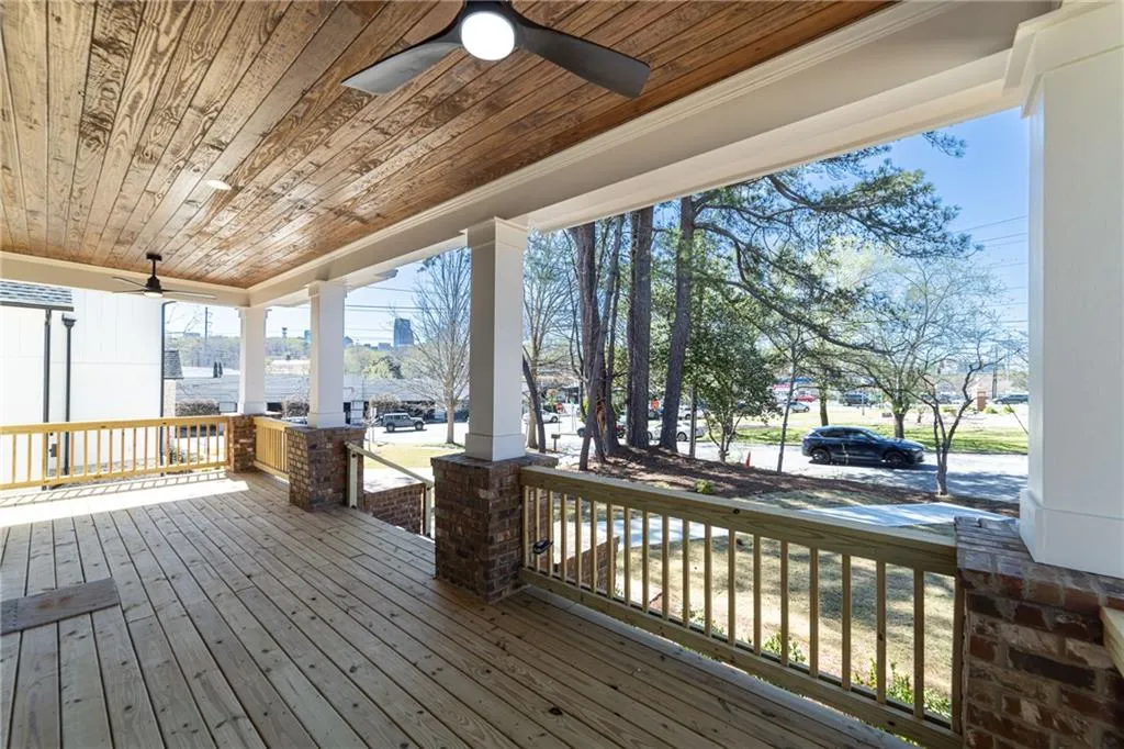 Wooden deck with covered porch and a ceiling fan