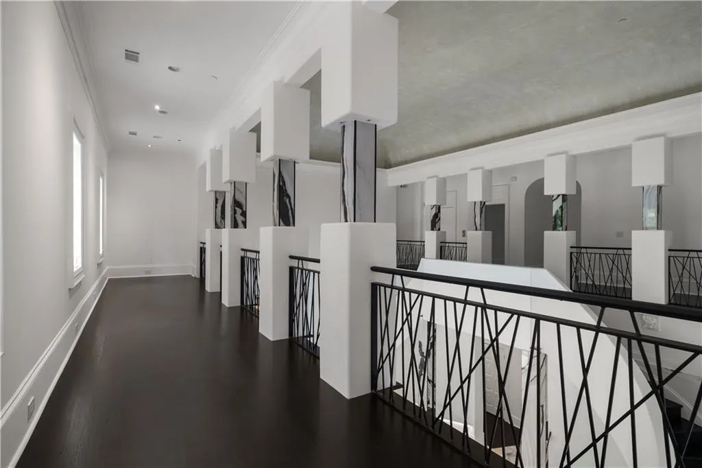 Unfurnished room featuring wood finished floors and high vaulted ceiling