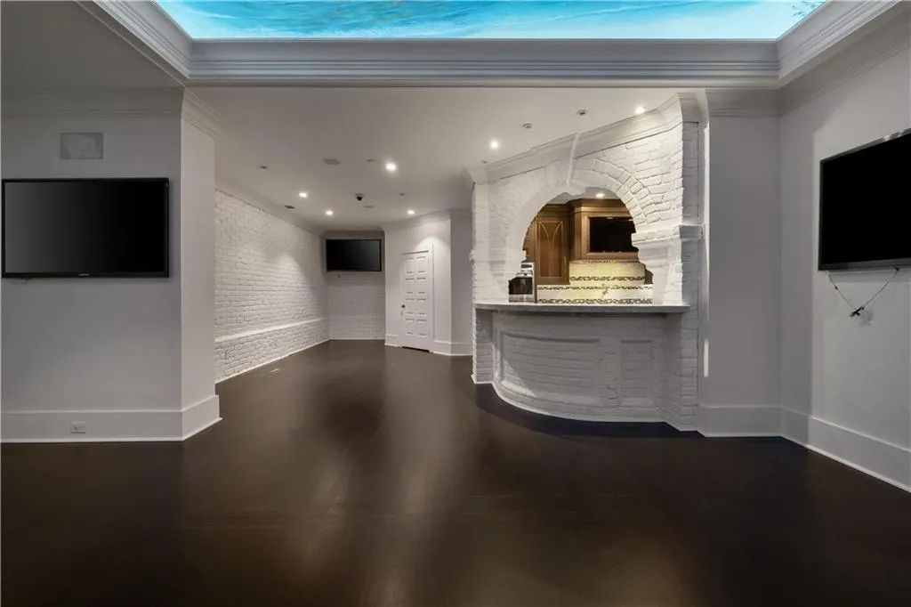 Reception featuring crown molding, brick wall, and recessed lighting