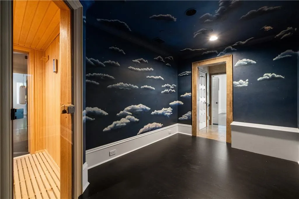 Hallway featuring a relaxing sauna and wood finished floors