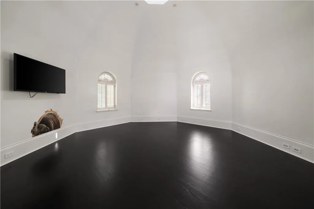 Empty room with ornamental molding and dark tile patterned floors