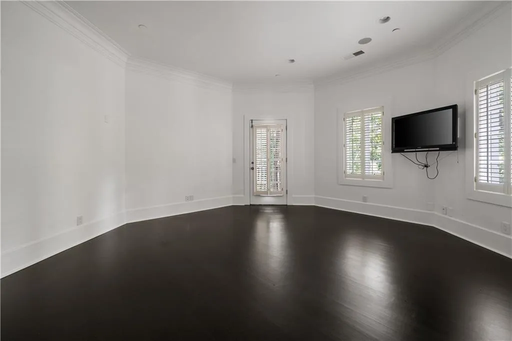Hallway with dark wood finished floors and ornamental molding