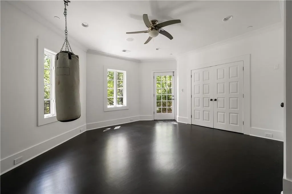 Hallway featuring wood finished floors and baseboards