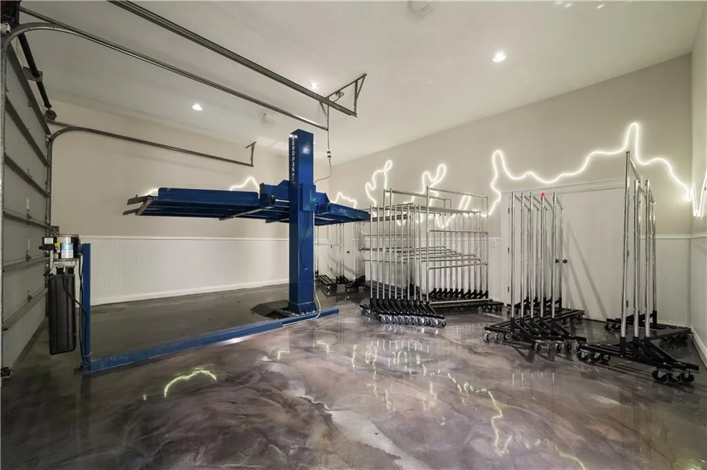 Garage featuring wainscoting and recessed lighting