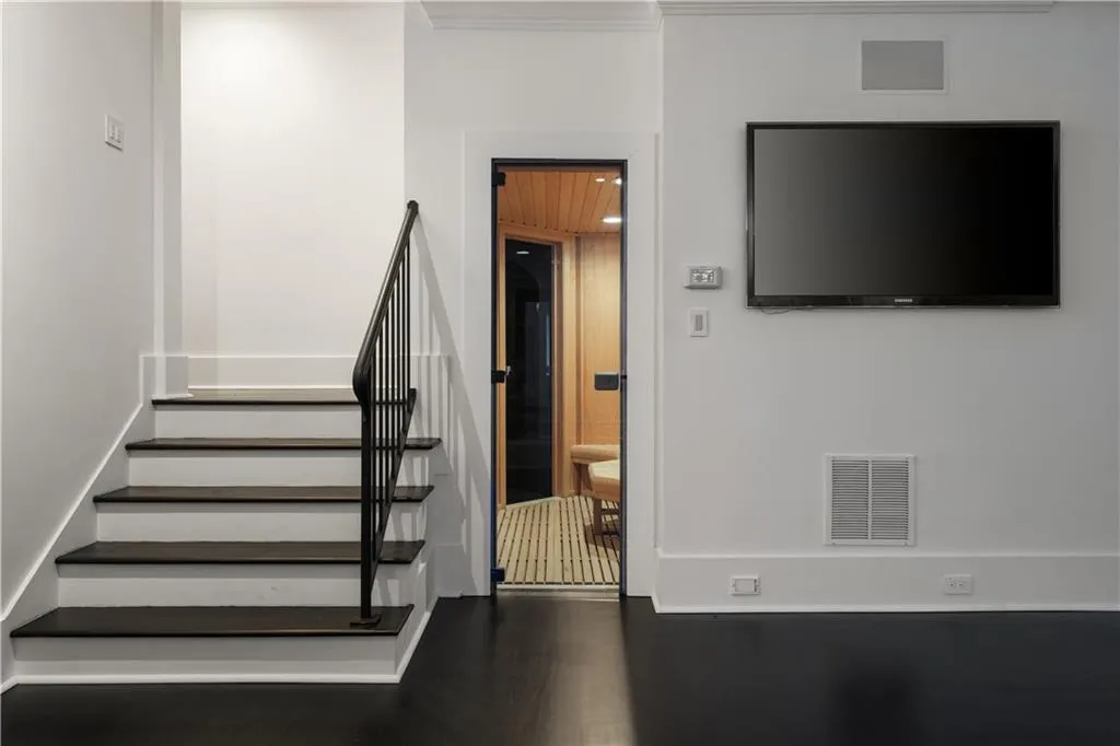 Unfurnished living room featuring crown molding, recessed lighting, and dark wood-style flooring