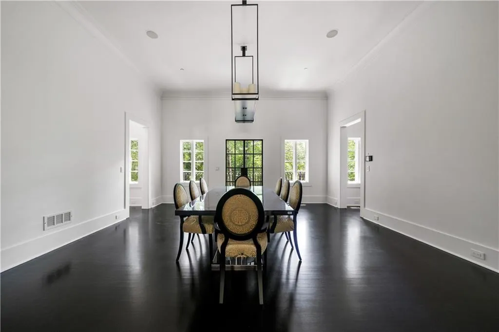 Dining room with ornamental molding and dark wood-style floors