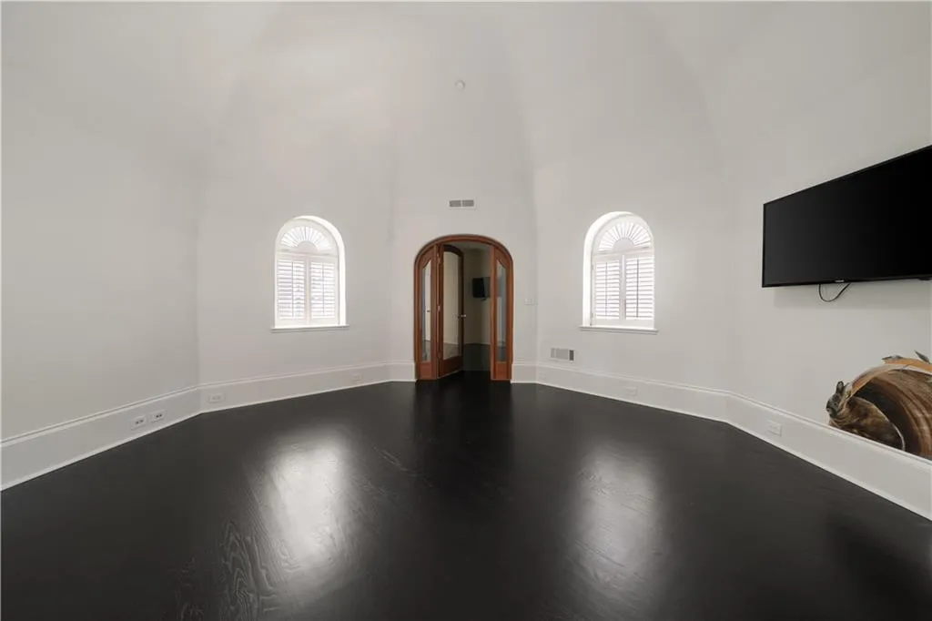 Empty room featuring healthy amount of natural light and ornamental molding