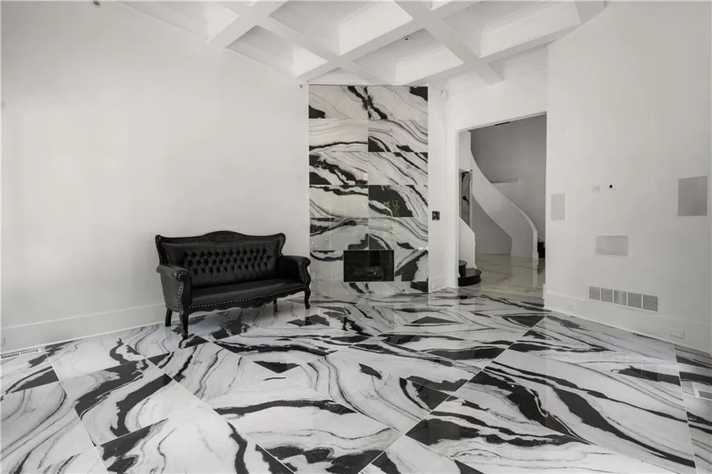 Sitting room featuring coffered ceiling, beam ceiling, and marble tiled floors