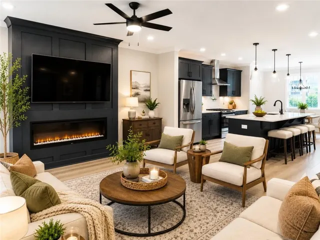 This photo is virtually staged. Inviting open-concept family room and kitchen showcasing the spacious layout, electric fireplace, large kitchen island, and beautiful modern finishes.