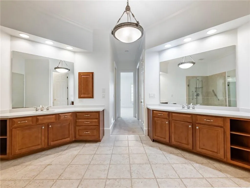 Large primary bathroom has dual vanities.