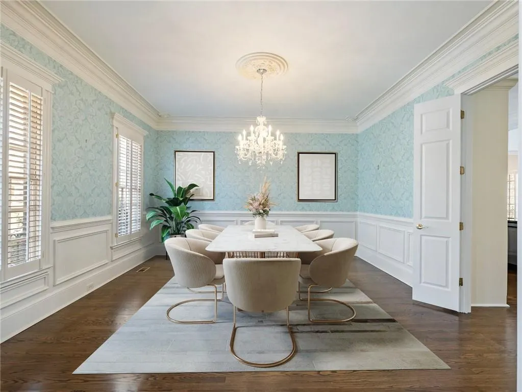 Dining area featuring plenty of natural light, a notable chandelier, and dark hardwood / wood-style flooring