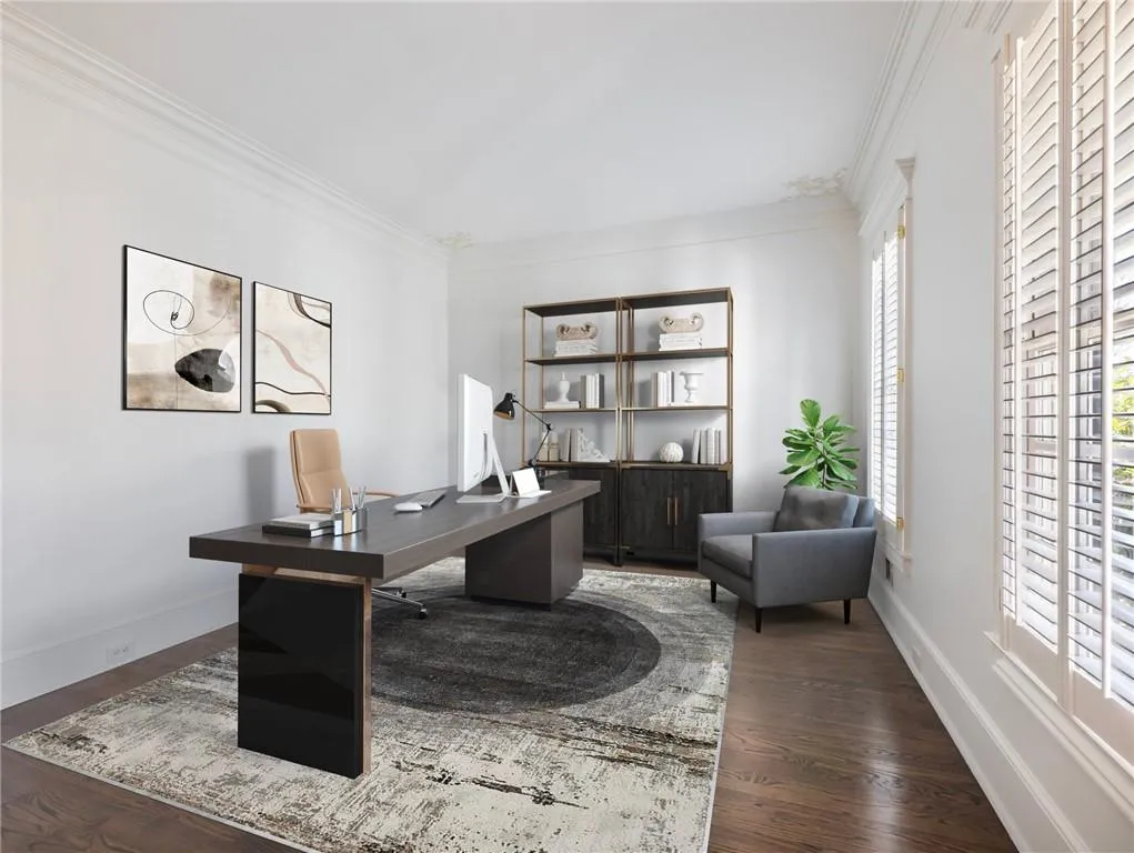 Office with dark hardwood / wood-style floors and ornamental molding.