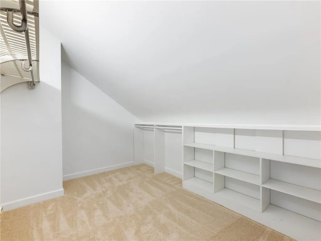 Spacious closet with lofted ceiling.