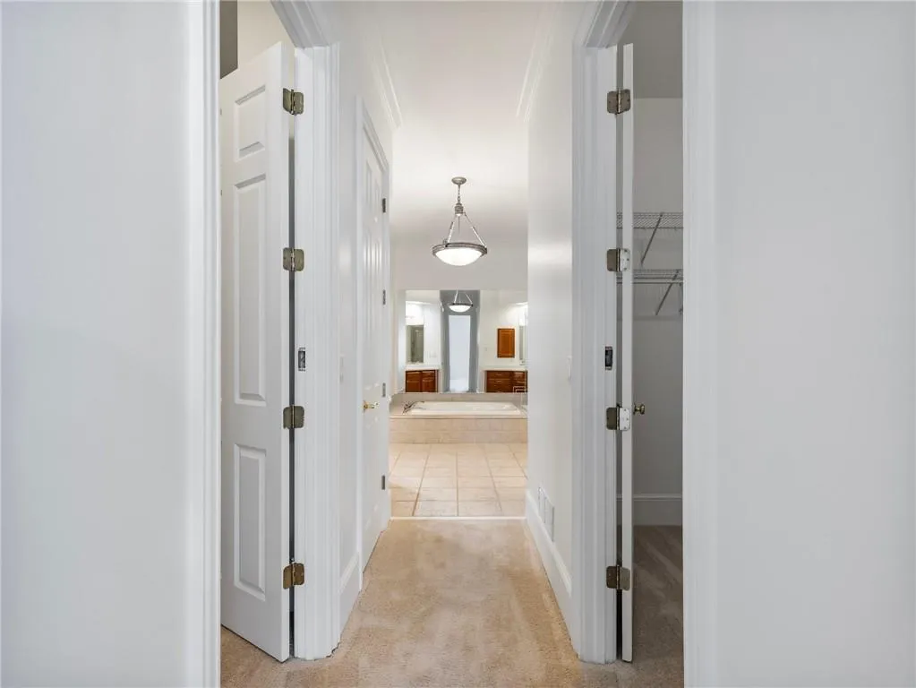 Primary suite features two walk-in closets on each side.