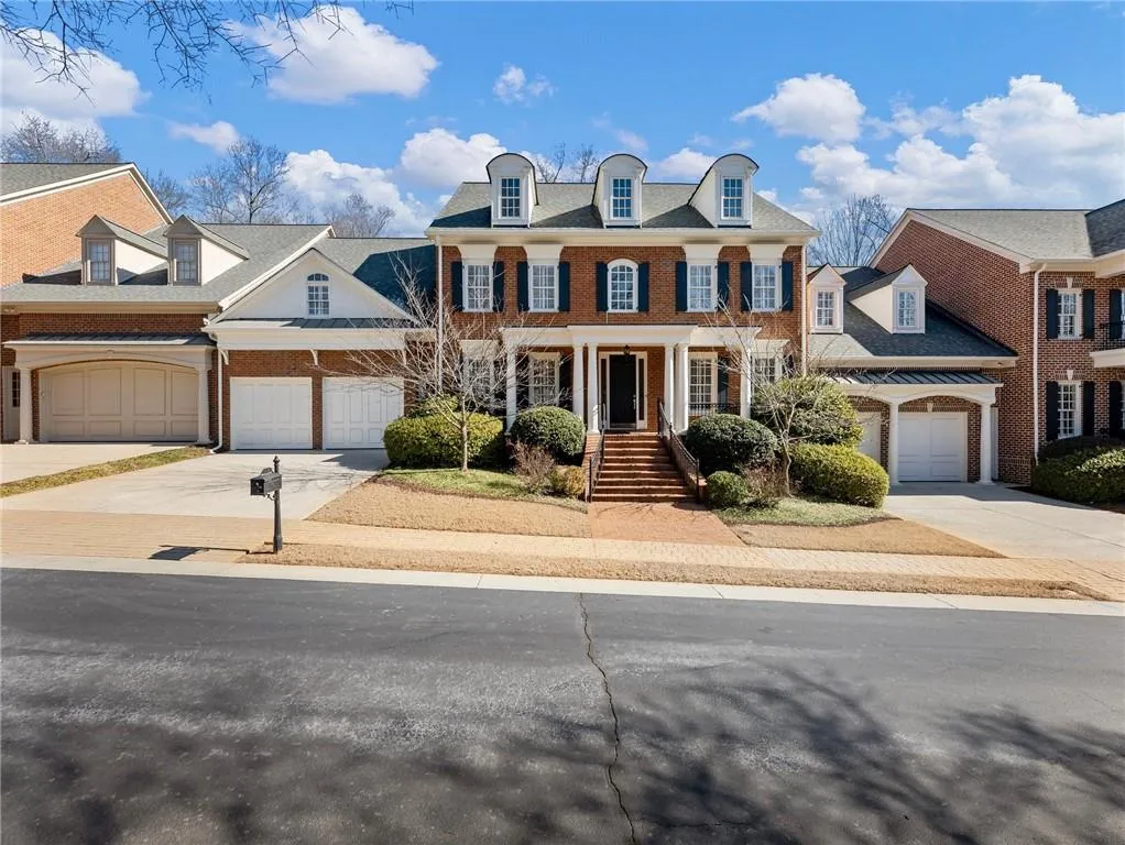 View of front of property featuring covered porch and garage.
