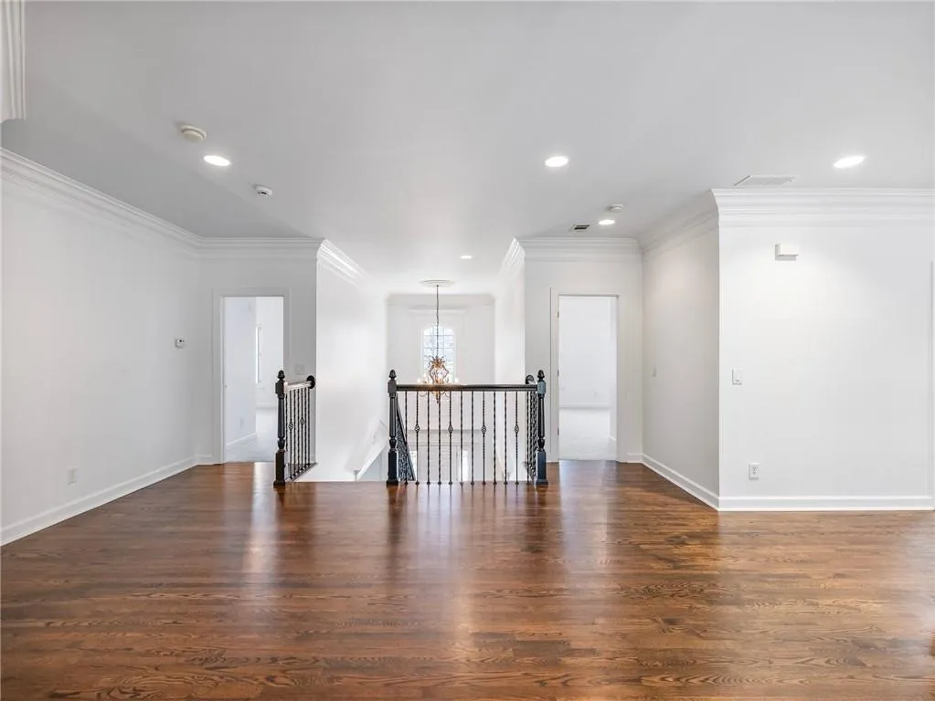 Landing area with doorway to one of four upstairs bedrooms.