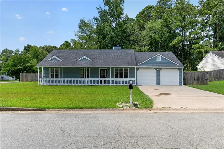 Ranch-style residence featuring a blue siding exterior, a dark shingle roof, and a full front porch with white railing