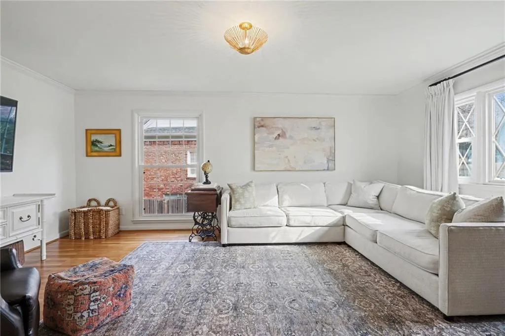 Living area featuring wood finished floors and ornamental molding