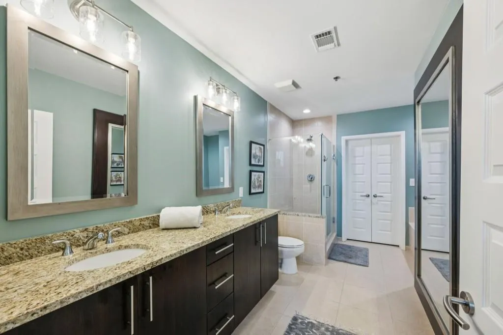 The Primary Suite offers serene views, Balcony Access, and a Spa-Like Bathroom with Dual Vanities, a Soaking Tub, a Separate Glass Shower, and Walk-In Closet.