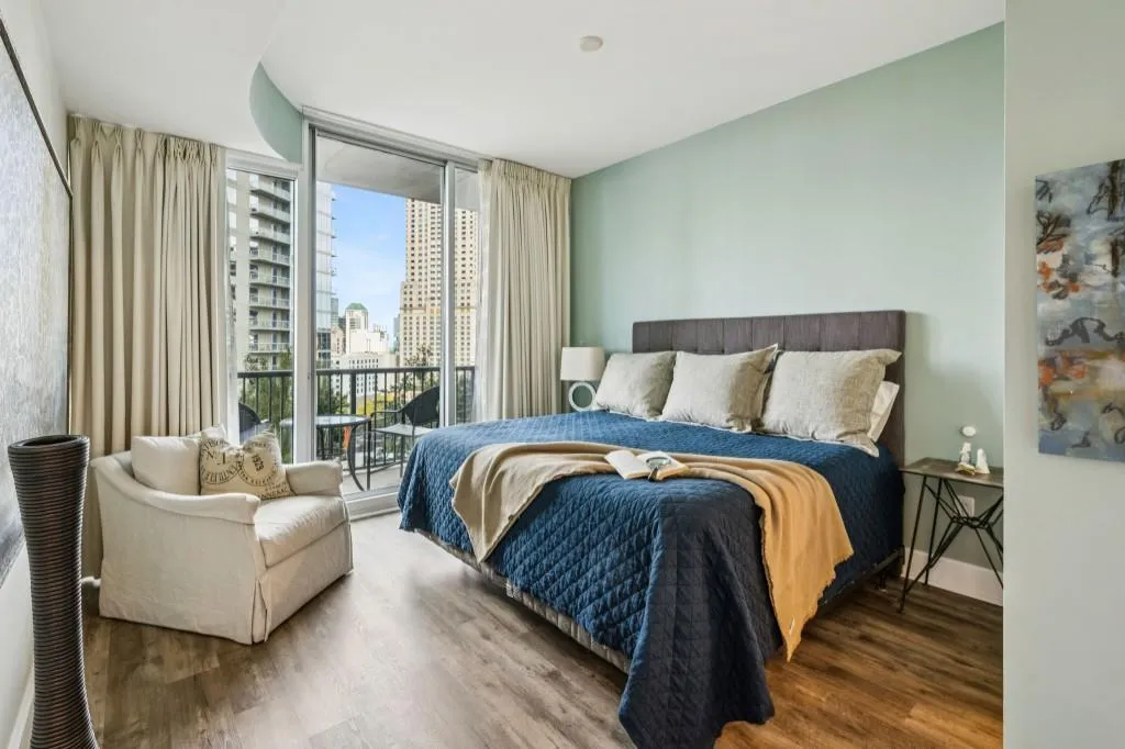 The Primary Suite offers serene views, Balcony Access, and a Spa-Like Bathroom with Dual Vanities, a Soaking Tub, a Separate Glass Shower, and Walk-In Closet.