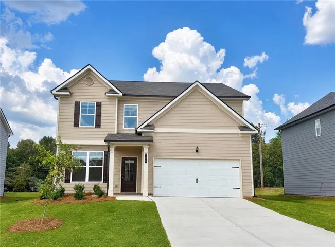 Front Exterior- Beautiful curb appeal with a covered front porch, professionally landscaped yard, and attached two-car garage.
