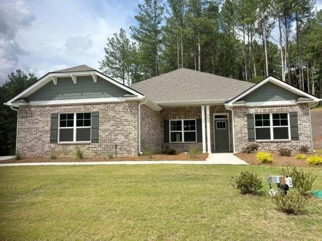 Brick exterior with shaker-style gable siding, white trim, and dark shutters