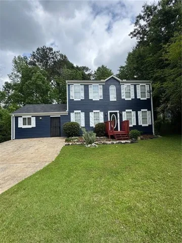 Two-story exterior with blue siding and white shutters