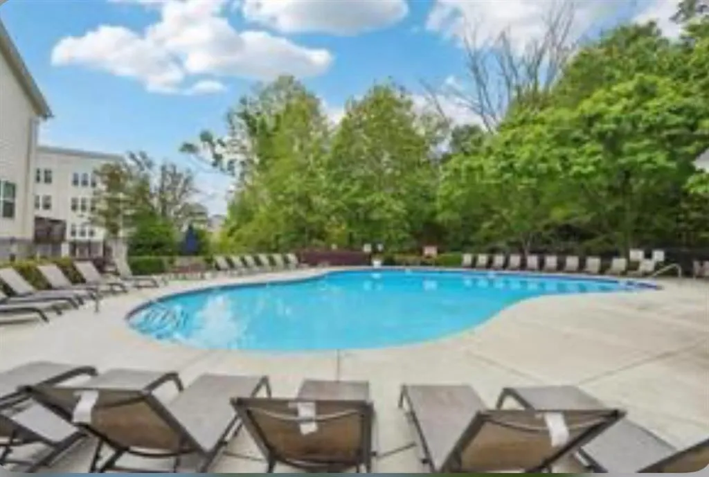 Community pool featuring a patio area