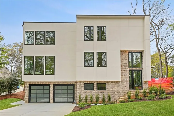 Modern home featuring brick siding and stucco siding