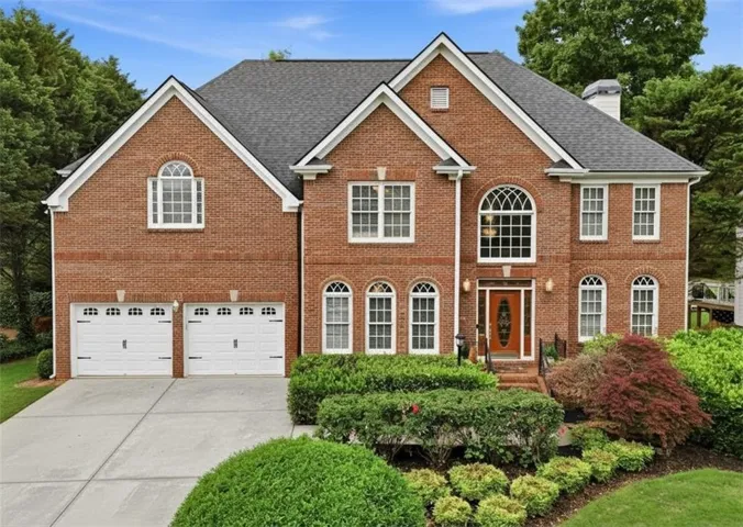 Brick exterior with a prominent arched transom window above the main entry