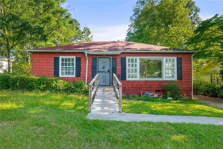 Bungalow-style house featuring a front lawn