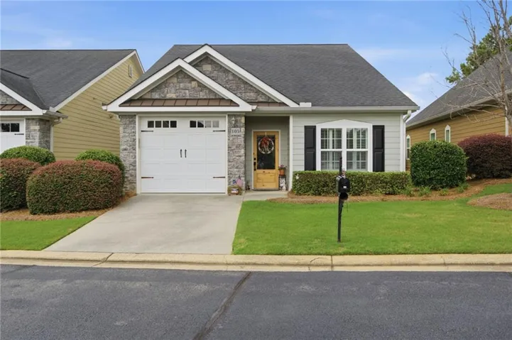 Craftsman-style exterior with stone and siding accents