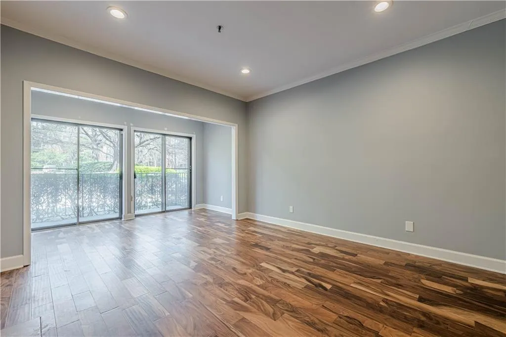 Unfurnished room with recessed lighting, ornamental molding, baseboards, and dark wood finished floors