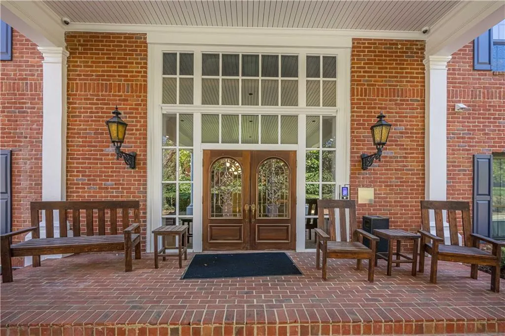View of exterior entry with brick siding and french doors