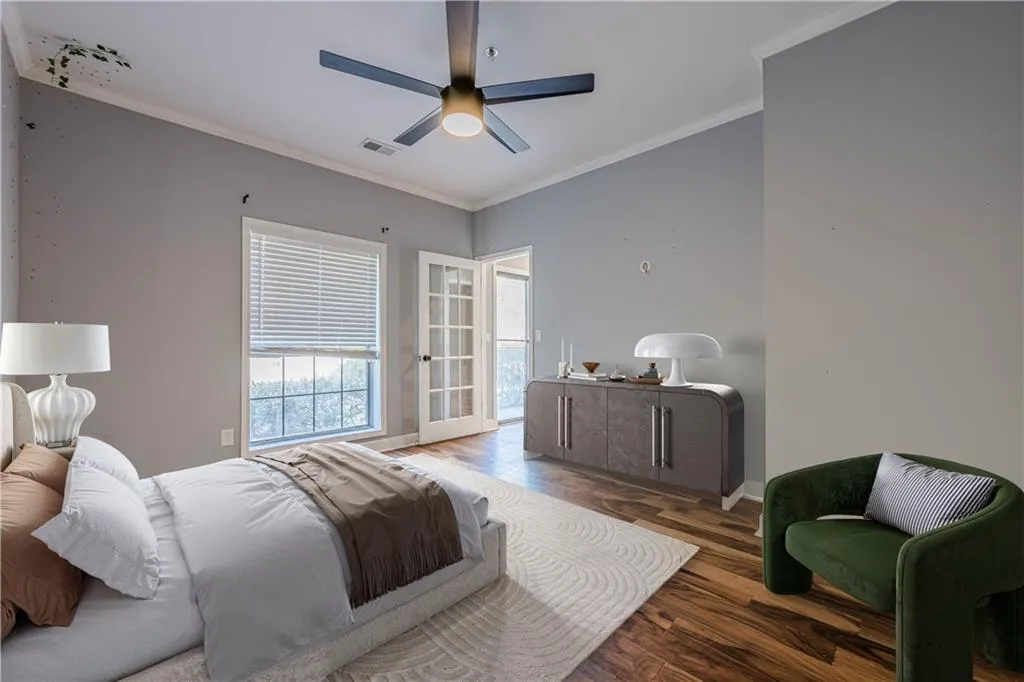 Bedroom featuring ornamental molding, wood finished floors, baseboards, and a ceiling fan
