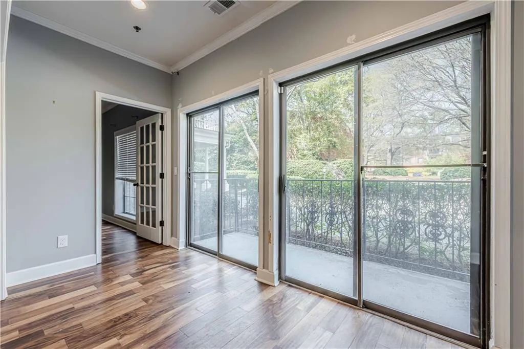 Doorway featuring recessed lighting, ornamental molding, baseboards, visible vents, and wood finished floors