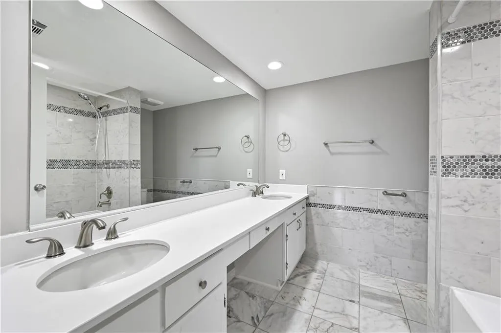 Bathroom featuring vanity and tile walls