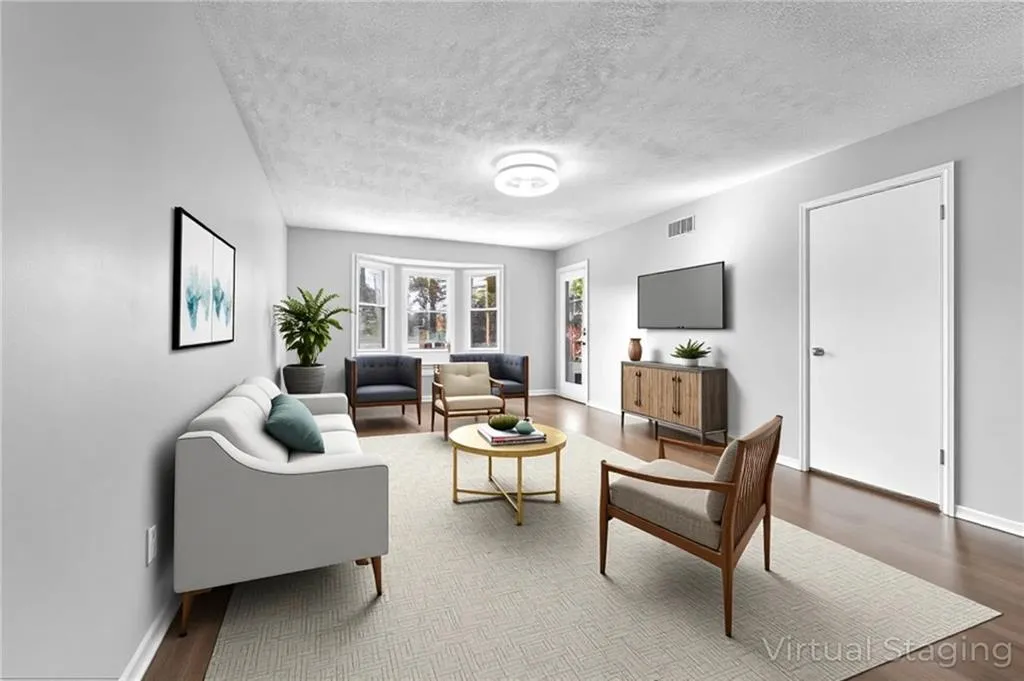 Living room featuring wood finished floors and a textured ceiling