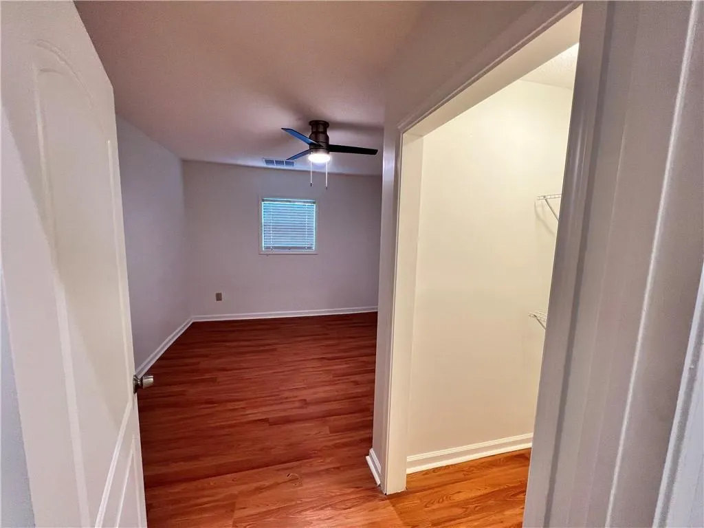 Yet, another spacious bedroom, with hardwood floors.