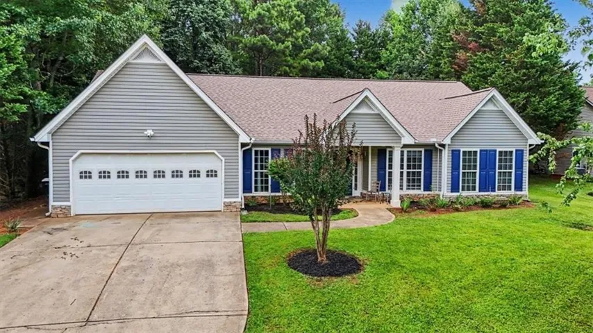 Ranch-style exterior featuring light gray siding with white trim and blue window shutters