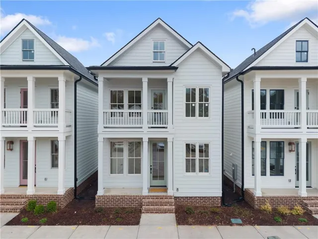 Contemporary two-story residence featuring white siding and black trim