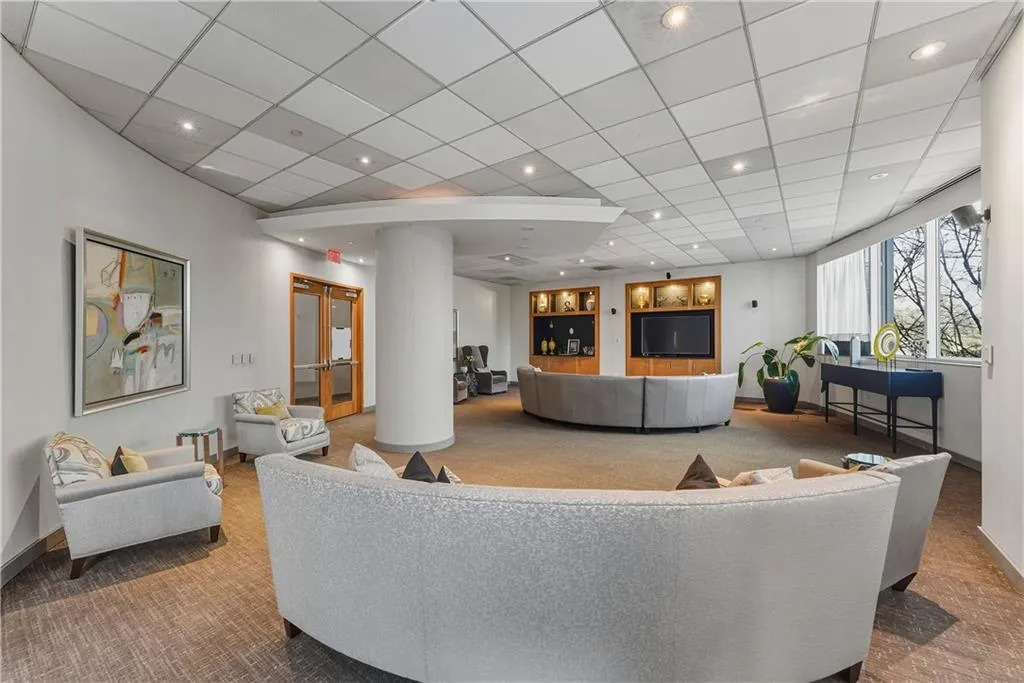 Spacious common area featuring recessed lighting, a built-in media center with shelving, expansive windows, and durable flooring