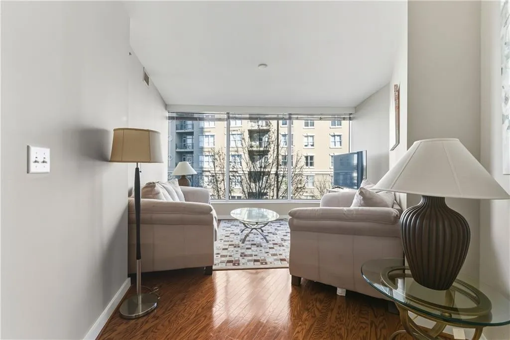 Hardwood flooring, floor-to-ceiling windows, recessed lighting, and light-toned walls