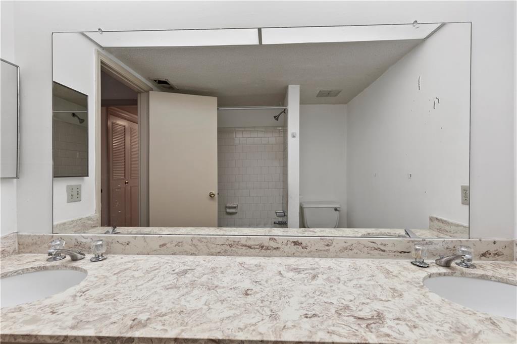 Bathroom featuring toilet and double vanity